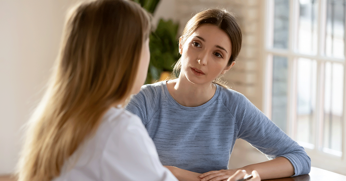 A woman speaks with a healthcare professional about STI testing and treatment during pregnancy.